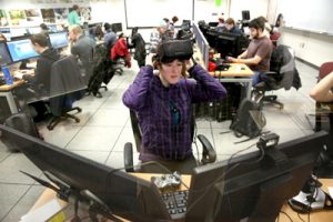 Wearing Oculus Rift virtual reality headsets, UW-Stout students test their video game prototypes.