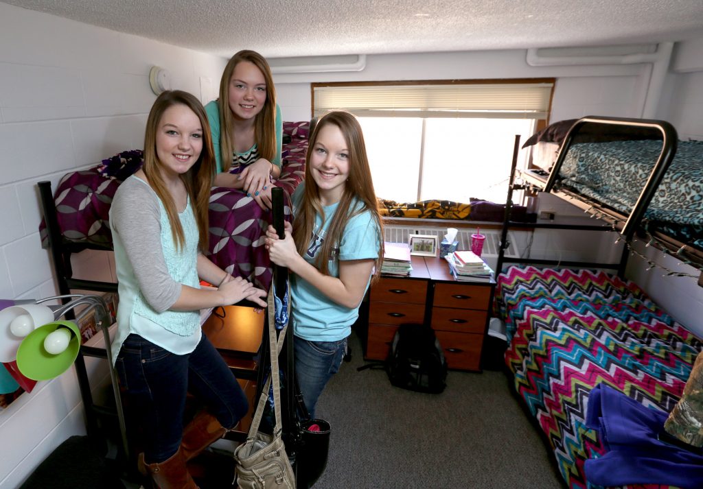 From left, Jeni, Joni and Jami Donath take a break in their residence hall room. The triplets from Clayton are freshmen at UW-Stout.