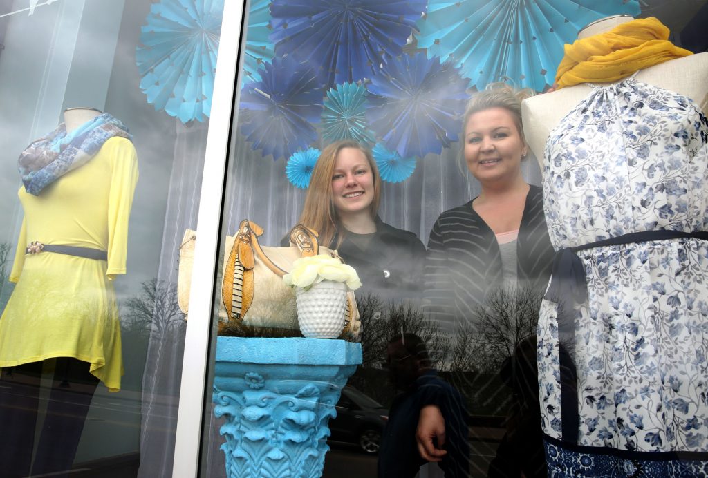 UW-Stout student Maria Krebs, left, and a classmate created a winning window display for Iris Boutique, owned by Leah Ritchie, right.