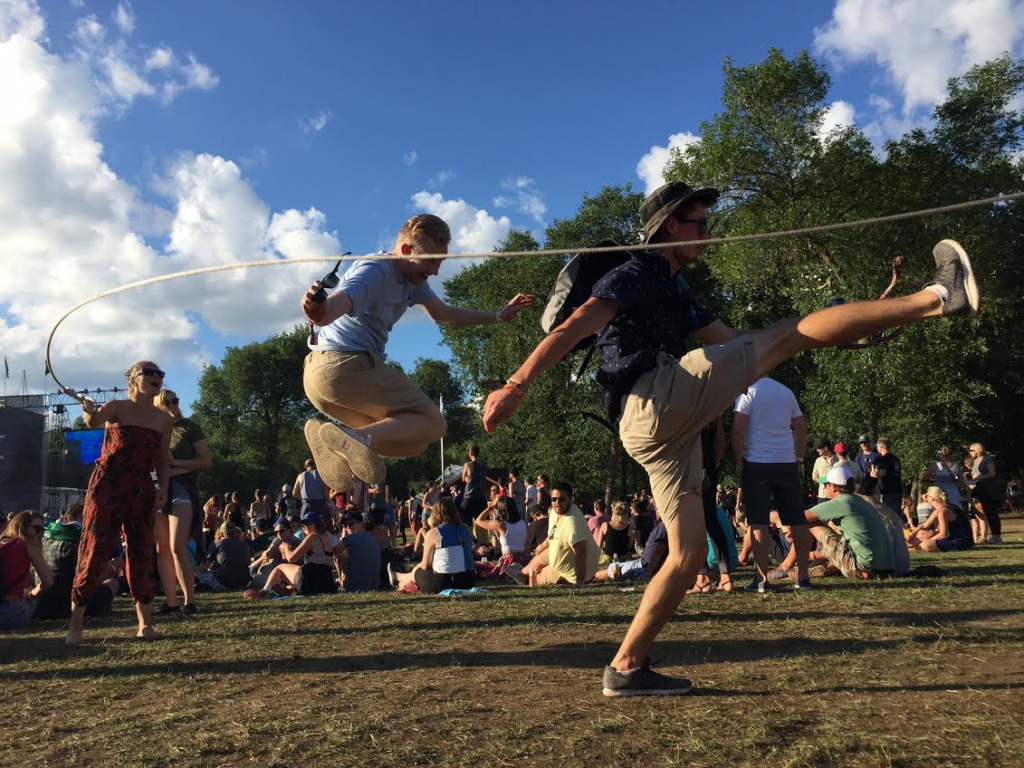  Festival-goers bring their own entertainment and talent with a jump rope while a band performs on the Lake Eaux Lune stage on Saturday afternoon (Aug. 13).