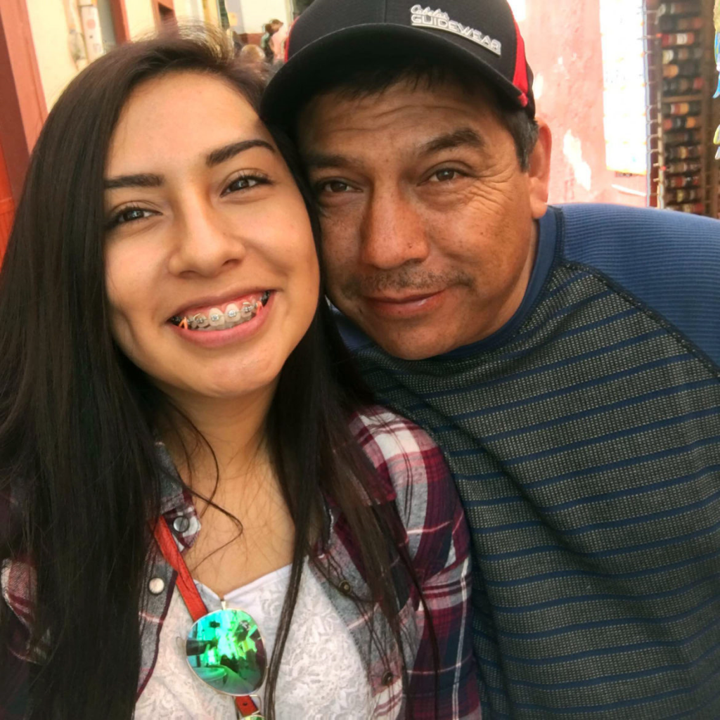 Beloit (Wis.) Memorial High School senior Andrea Montes, seen here with her father, Manuel, looks forward to voting for the first time this year. Montes, a member of the school’s varsity soccer team, says she is motivated by a racially charged incident at a game in Elkhorn in which opposing fans chanted “Build that wall!” at Latina members of Beloit’s junior varsity squad. Montes’ family is originally from Mexico. (Photo provided by Andrea Montes, via the Wisconsin Center for Investigative Journalism)