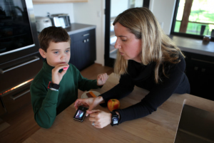 Jack Christensen, 8, with his mother, Jess Franz-Christensen, at their home in Waunakee, on Oct. 5, 2016. Jack has Type 1 diabetes and his parents wear watches to monitor his blood sugar level 24 hours a day. Rapidly rising insulin costs have prompted his mother to become a parent activist pushing for lower drug prices. (Photo by Coburn Dukehart/WCIJ)