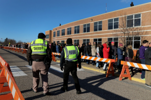 Eau Claire law enforcement personnel monitor the crowd outside of Memorial High School on Apr. 2, 2016, as they wait to see Donald Trump speak. Trump is among the candidates whose campaigns owe communities in Wisconsin thousands of dollars for police protection in 2016, according to a Center for Public Integrity investigation. (Photo by Marisa Wojcik/Eau Claire Leader-Telegram)