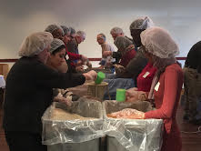 Volunteers packing meals at last week's Rotary Club event in Menomonie.